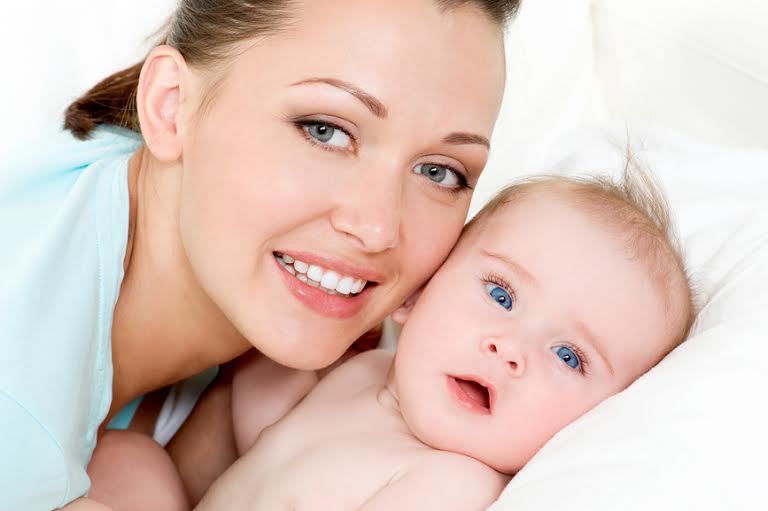 Closeup faces of young happy mother with cute newborn baby